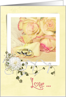 wedding anniversary rings on rose petal with bouquet on frame card
