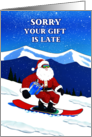 Belated Christmas Funny Snowboarding Santa with a Wrapped Present card