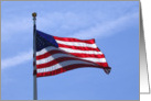 American Flag at full mast flying high against a blue sky card