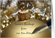 Season’s Greetings from new home - fountain pen writing christmas message on golden ornament card