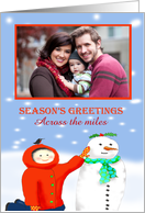 Season’s Greetings across the miles ,Child and snowman, photo frame. card