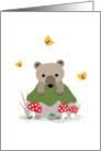 Bear cub and butterflies behind mossy forest rock card