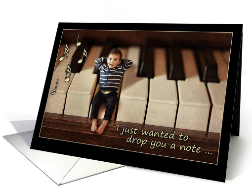Thinking of you, miniature baby on piano keyboard, blank card