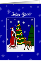 Happy Yule Santa decorating Tree with Deer and Snowflakes card