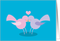 Snuggling love birds with a heart card