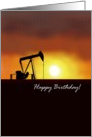 Oil pump jack against sunset sky, birthday card