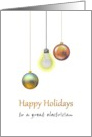 Happy Holidays for Electrician Baubles Hanging Next to Lit Light Bulb card