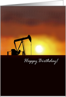 Oil pump jack against sunset sky, birthday card