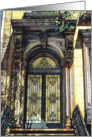 A brownstone doorway with decorative wrought iron card