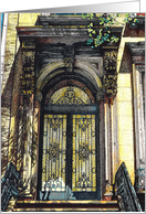 A brownstone doorway with decorative wrought iron card