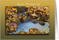 Happy Thanksgiving autumn leaves falling around a country stream card