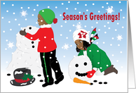 Christmas - Boy and girl having fun building a snowman card