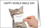 Happy World Smile Day Tabby Kitten with a Paper Smile card