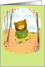 Cute little bear kicking up Fall leaves in the woods. card