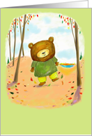 Cute little bear kicking up Fall leaves in the woods. card