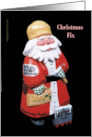 A Carved Wooden Santa Offering a Christmas Fix with a Blank card