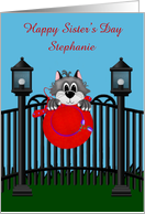 Sister’s Day Custom Name Card with a Cat on a Fence Holding a Red Hat card