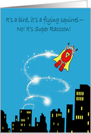 Birthday with a Superhero Raccoon Flying above City Buildings card