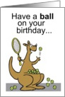 Cartoon kangaroo playing tennis with racquet and balls. card