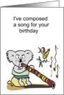 Cartoon koala playing a song on a didgeridoo watched by colorful bird card