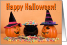 Pumpkin witches with cauldron of candy wishing Happy Halloween card