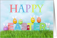 Colorful eggs bunnies in grass wishing Happy Easter card