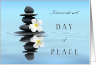 International Day of Peace with Calm Water Rock Stack and Flower card