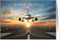 Happy New Year with Plane Landing on Runway at Sunset card